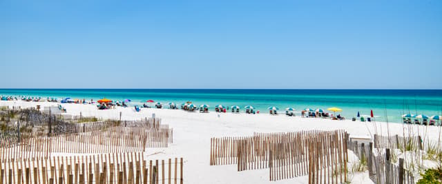 Destin beach with white sand dunes and turquoise Gulf water