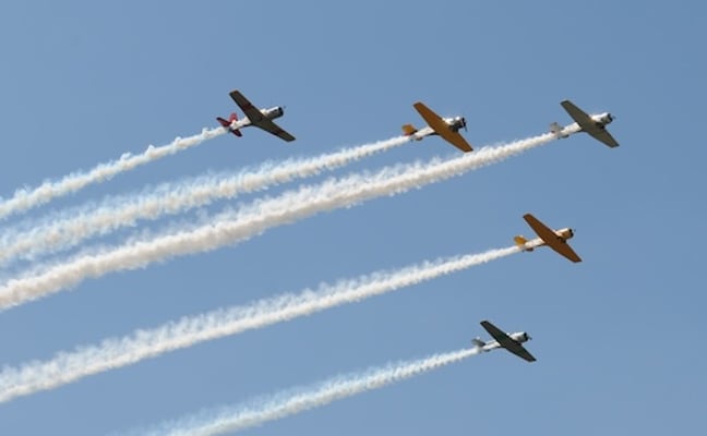 Vintage planes flying in formation at an air show